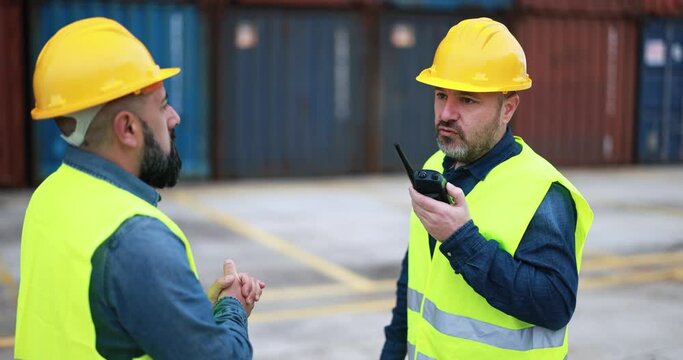 Engineer people controlling shipping containers inside industrial port