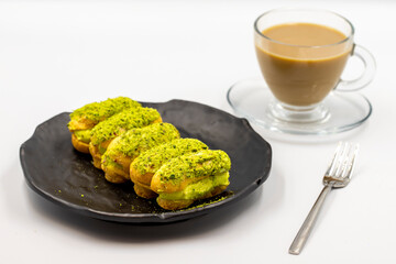 Eclair cake with pistachio isolated on white background. Close-up.