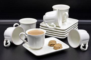Porcelain coffee set on a black background. Close up