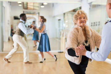 Mature woman at a group training in studio of dance