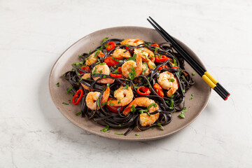 Black pasta with roasted prawns.