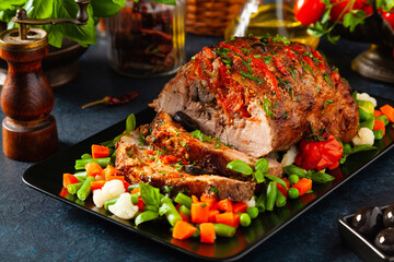 Whole roasted, stuffed with tomatoes and olives, pork neck.