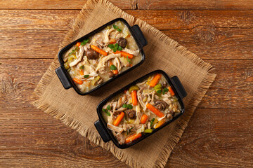 Chicken casserole. Served in black pots.