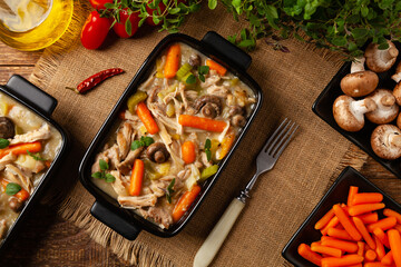 Chicken casserole. Served in black pots.