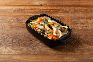 Chicken casserole. Served in black pots.