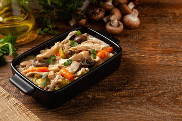 Chicken casserole. Served in black pots.