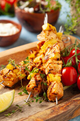 Grilled shashlik with salmon and pineapple. Served with yoghurt sauce.