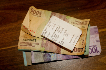 Naklejka premium Coins change on the receipt. Indonesian rupiah currency