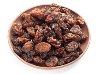 Raisin in clay plate isolated on white background. Macro. Healthy food concept