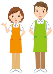 エプロンをつけた男女　案内する介護士　スタッフ