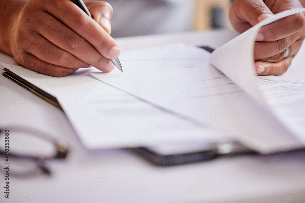 Poster filling in some paperwork. cropped shot of an unrecognizable businessman filling out paperwork while
