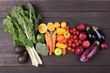 Overhead view of various fresh organic fruits and vegetables on table, copy space
