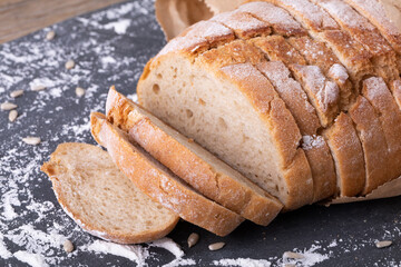 Close-up of sliced bread with flour on food slate