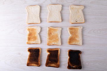 Directly above shot of toasted and burnt bread slices arranged on table - Powered by Adobe