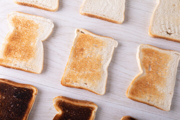 Full frame shot of toasted and burnt bread slices on table with copy space