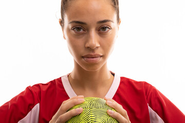 Close-up portrait of biracial young female handball player with ball against white background - obrazy, fototapety, plakaty