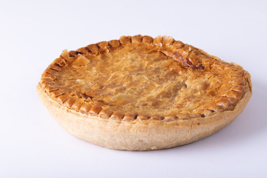 Close-up of baked stuffed pie against white background