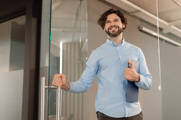 Portrait of smiling business man walking in office