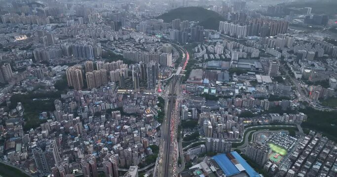 Aerial footage night view of modern city buildings with interchange overpass in shenzhen city,China