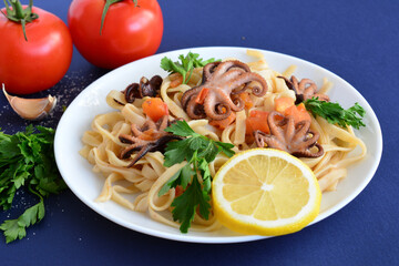 pasta with seafood and tomatoes and fresh parsley, close-up