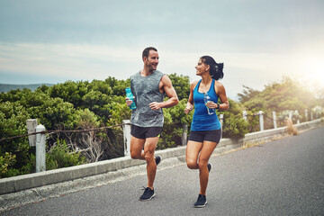 We got to know each other through fitness. Shot of a young attractive couple training for a marathon outdoors.