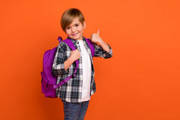 Photo of young cheerful boy show finger thumb-up perfect approve select feedback isolated over orange color background