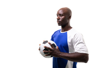 Confident african american male soccer player holding ball looking away against white background - Powered by Adobe