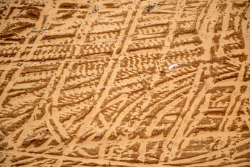 Textural sand, with  relief surface, multi-colored layers and different in size of granules, in outdoor sand career, after mining ore and sand for construction.