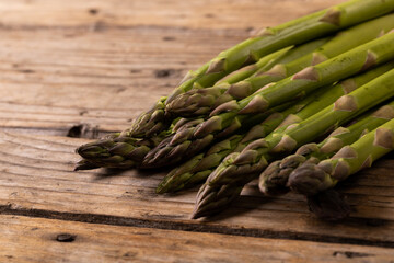 Close-up of raw green asparagus vegetable on wooden table