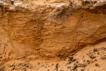 Textural sand, with  relief surface, multi-colored layers and different in size of granules, in outdoor sand career, after mining ore and sand for construction.