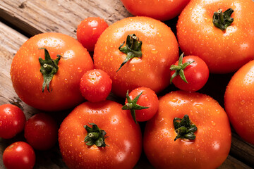 Directly above view of fresh red tomatoes with water drops on table
