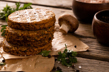 Fototapeta premium Close-up of patties stacked by edible mushroom on wooden table