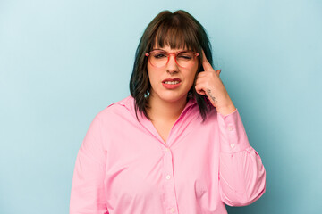 Young caucasian woman isolated on blue background showing a disappointment gesture with forefinger.