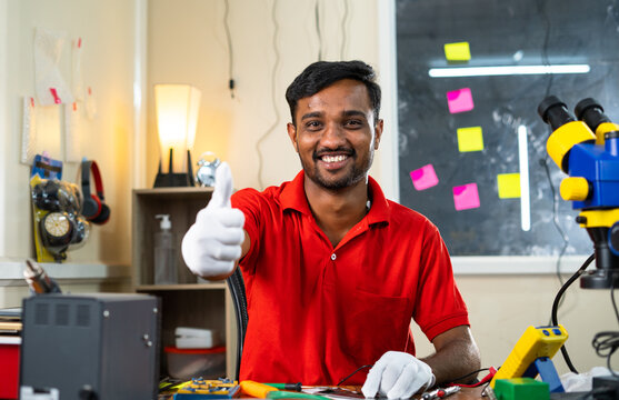 Happy Repairman Showing Thumbs Up Sign By Looking At Camera While At Mobile Repair Shop - Concept Of Recommendation, Approval And Successful Small Business