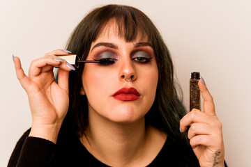 Obraz premium Young makeup artist woman holding a mascara isolated on white background