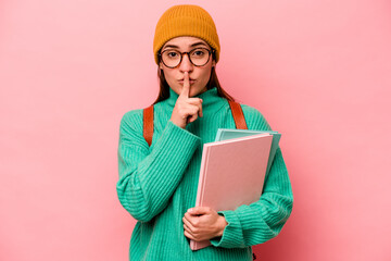 Young student caucasian woman isolated on pink background keeping a secret or asking for silence.