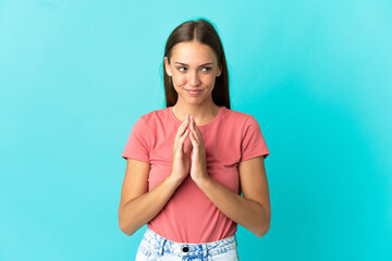 Young woman over isolated blue background scheming something