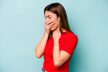 Young caucasian woman isolated on blue background suffers pain in throat due a virus or infection.