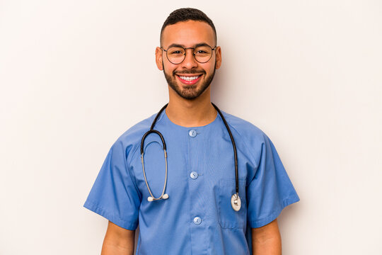 Young Hispanic Nurse Man Isolated On White Background Happy, Smiling And Cheerful.