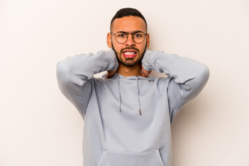 Young hispanic man isolated on white background screaming with rage.