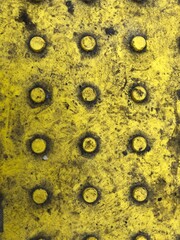 Yellow dirty block lyingpn the road. Close-up photo of yellow city tiles.