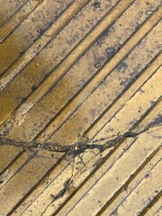 Yellow broken block lying in the rain. Close-up photo of yellow city tiles.