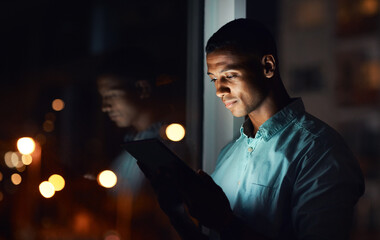 Its time you also get connected. Shot of a handsome young businessman using a digital tablet while working late in his office. - Powered by Adobe