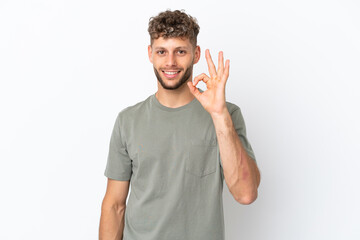 Young caucasian handsome man isolated on white background showing ok sign with fingers