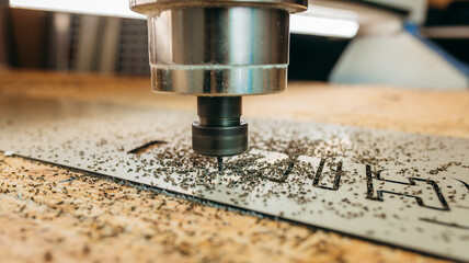 CNC drilling machine is working with metal plate. Close-up