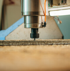 CNC drilling machine is working with metal plate. Close-up