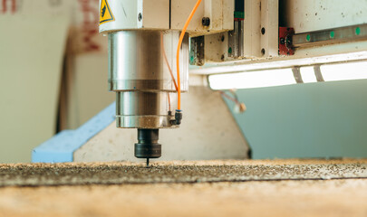 CNC drilling machine is working with metal plate. Close-up