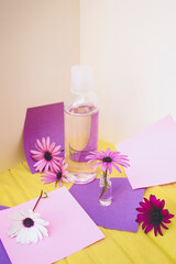 Still life of eco cosmetics with flowers in paper background design