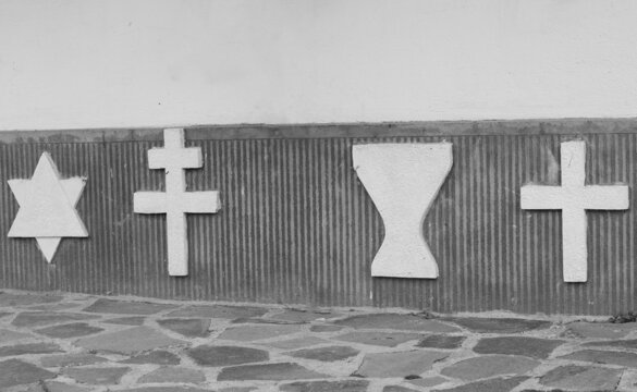 The Symbols Of Several Religious Denominations On An Old Wall