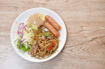 fried spicy spaghetti bacon with pork sausage and mashed potato dressing gravy sauce couple salad on plate